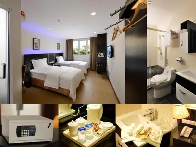 a hotel room with a bed and a bathroom at ERNES Hotel Bayu Mutiara in Bukit Mertajam
