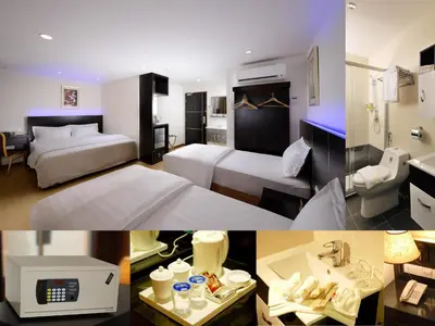 a hotel room with two beds and a bathroom at ERNES Hotel Bayu Mutiara in Bukit Mertajam