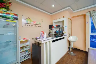a guest house with a counter in a room at Hotel O V Stay Guesthouse in Ayer Itam