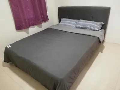 a bed with two pillows on it in a room at Green View Home Cameron Highlands in Brinchang