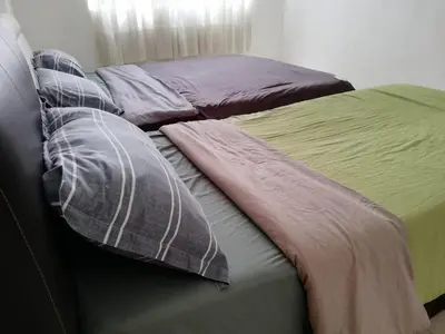 a bed with two pillows on top of it at Green View Home Cameron Highlands in Brinchang