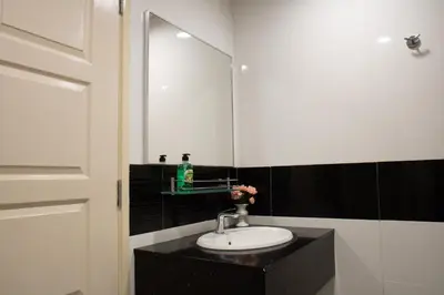 a bathroom with a sink and a mirror at Profolio @ Mansion One in George Town