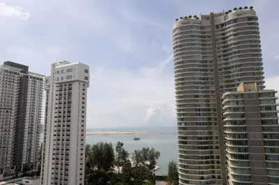 two tall buildings next to a body of water at Profolio @ Mansion One in George Town
