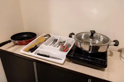 a stove top with a pot and a pan on it at Profolio @ Mansion One in George Town