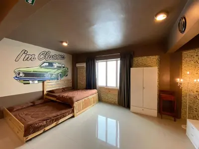 a bedroom with a car sign on the wall at ANTZ Village Studio in Kampar