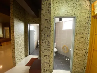 a bathroom with a shower and a toilet at ANTZ Village Studio in Kampar