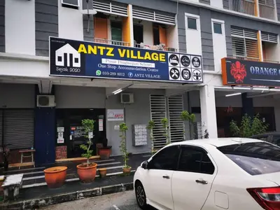 a white car parked in front of a building at ANTZ Village Studio in Kampar