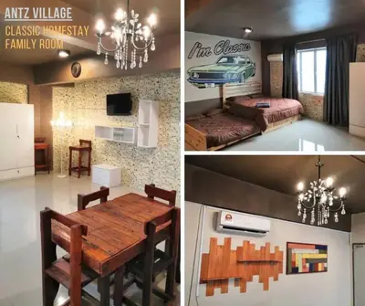 a room with a dining table and a bedroom at ANTZ Village Studio in Kampar