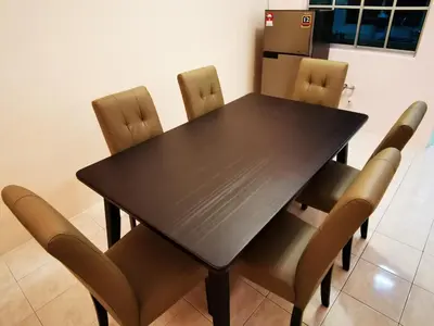 a black dining room table with brown chairs at Bidor Totoro and One piece animation house in Kampong Kuala Gepal