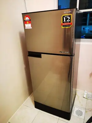 a stainless steel refrigerator with two stickers on it at Bidor Totoro and One piece animation house in Kampong Kuala Gepal
