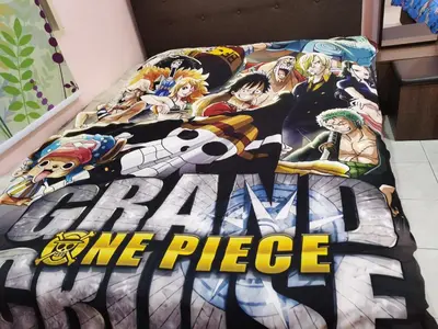 a bed with a bedspread that reads boku no poke pile at Bidor Totoro and One piece animation house in Kampong Kuala Gepal