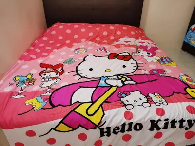 a bed with a hello kitty comforter on it at Bidor Totoro and One piece animation house in Kampong Kuala Gepal