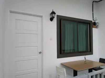a room with a door and a table and a mirror at Ng Family’s Farm Stay in Cameron Highlands