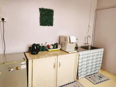 a kitchen with a counter with a microwave and a refrigerator at LUNAS DIY HOMESTAY in Lunas