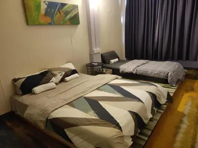 a bedroom with two beds and a window at LUNAS DIY HOMESTAY in Lunas