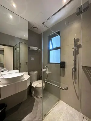 a bathroom with a toilet and a sink and a shower at The Gallivant Hotel in George Town
