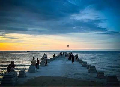 a group of people walking on the beach at DELUXE Suite Seaview Batu Ferringhi 2304 - 2 Rooms in Batu Ferringhi