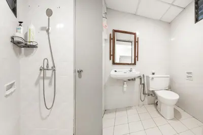 a bathroom with a shower and a toilet and a sink at DELUXE Suite Seaview Batu Ferringhi 2304 - 2 Rooms in Batu Ferringhi