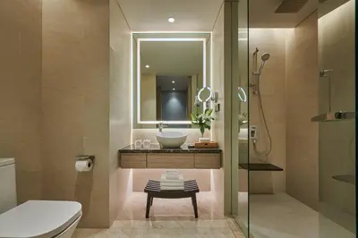 a bathroom with a sink and a toilet and a mirror at Courtyard by Marriott Penang in George Town