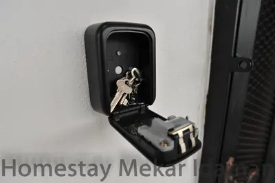 a lock on a door with a key in it at homestay mekar idaman in Kepala Batas