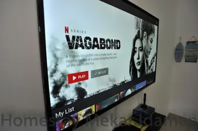 a flat screen tv sitting on a wall at homestay mekar idaman in Kepala Batas