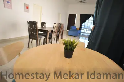 a wooden table with a potted plant on top of it at homestay mekar idaman in Kepala Batas