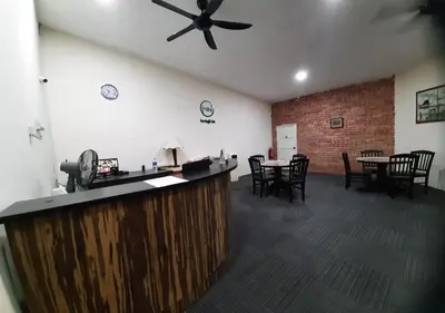 a bar in a room with tables and chairs at MN Ferringhi Inn in Batu Ferringhi
