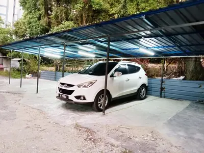 a white car parked in a parking lot at MN Ferringhi Inn in Batu Ferringhi