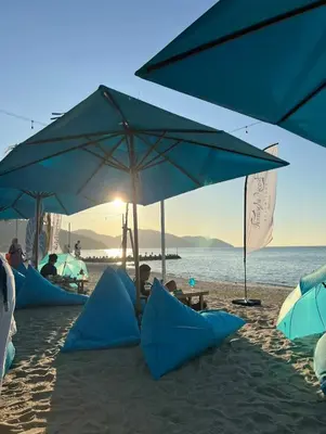 a group of blue umbrellas on a sandy beach at Pantai Seaview Resort Batu Ferringhi 1801 - 3 Rooms in Batu Ferringhi