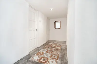 an empty hallway with a rug on the floor at Pantai Seaview Resort Batu Ferringhi 1801 - 3 Rooms in Batu Ferringhi