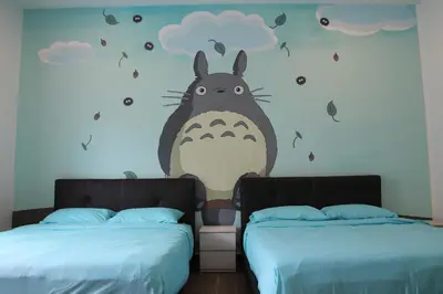 a bedroom with two beds and a mural of a donkey at Bricks Terrace House 4R 3BR (Near to Night Market) in Brinchang