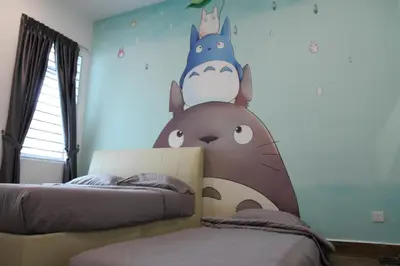 a bedroom with two beds with a dinosaur wall at Bricks Terrace House 4R 3BR (Near to Night Market) in Brinchang