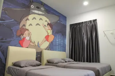 a room with two beds and a painting of a monster at Bricks Terrace House 4R 3BR (Near to Night Market) in Brinchang
