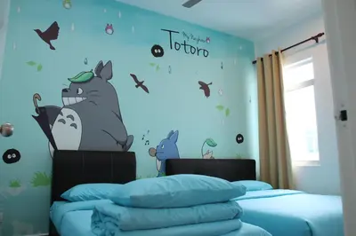 a bedroom with a bed with a hello kitty wall mural at Bricks Terrace House 4R 3BR (Near to Night Market) in Brinchang