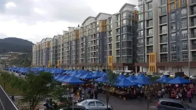 a crowd of people standing in front of a large building at Bishops Cap at Cameron Highlands in Brinchang