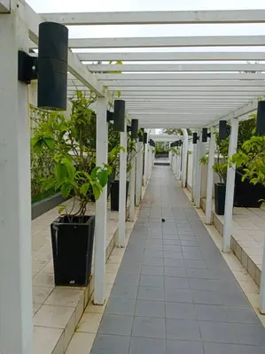 a hallway with potted plants in a building at Bishops Cap at Cameron Highlands in Brinchang