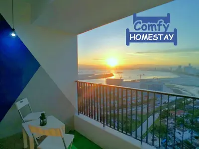 a balcony with a view of the ocean and the sunrise at Pulau Andaman Gurney Bay View The Landmark by Comfy in George Town