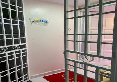 a room with a gate and a door with a red rug at My Suites Sri Sayang Resort in Batu Ferringhi
