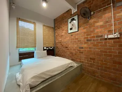 a brick walled bedroom with a bed in a brick room at URBANSTAY AT IPOH (STANDARD ROOM) in Ipoh