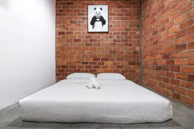 a bed in a room with a brick wall at URBANSTAY AT IPOH (STANDARD ROOM) in Ipoh