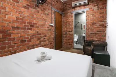 a teddy bear sitting on a table in a brick room at URBANSTAY AT IPOH (STANDARD ROOM) in Ipoh