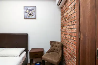 a bedroom with a bed and a brick wall at URBANSTAY AT IPOH (STANDARD ROOM) in Ipoh