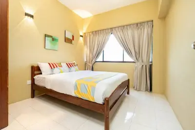 a bedroom with a large bed and a window at VIP Suite Seaview Resort Batu Ferringhi 1202 - 3 Rooms in Batu Ferringhi