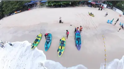 a group of people standing in the snow next to kayaks at VIP Seaview Resort Batu Ferringhi 2104 - 2 Rooms in Batu Ferringhi