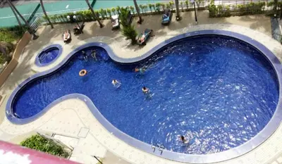 an overhead view of a large swimming pool at PoolView Resort Batu Ferringhi 502 - 2 Rooms in Batu Ferringhi