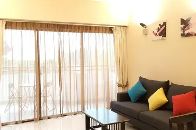 a living room with a couch and a large window at PoolView Resort Batu Ferringhi 502 - 2 Rooms in Batu Ferringhi