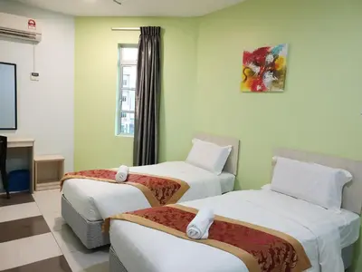 a hotel room with two beds and a tv at LH Hotel Langkap Perak in Kampung Degong