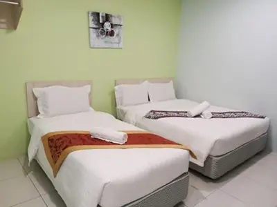 two beds in a room with white walls at LH Hotel Langkap Perak in Kampung Degong