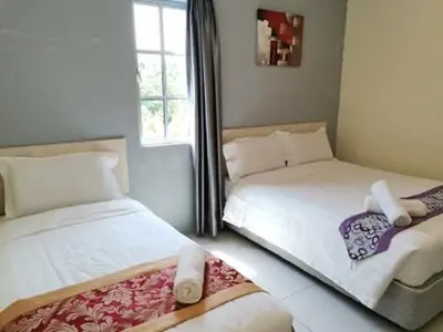a bedroom with two beds and a window at LH Hotel Langkap Perak in Kampung Degong