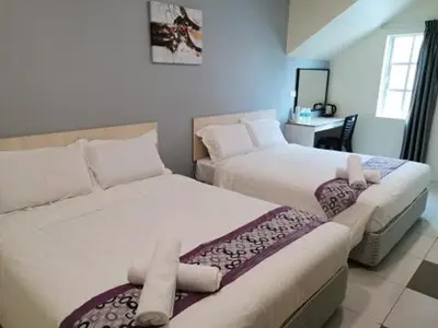 a bedroom with two beds and a table with a mirror at LH Hotel Langkap Perak in Kampung Degong